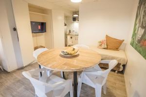 a room with a table and chairs and a couch at FOREST Nest with Self-Service Breakfast - Birds, Monkeys, Pet Friendly with a Fee in Subic Bay Intl