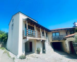 a large white building with a balcony on it at Studio Vila Olga in Dutovlje