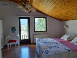 a bedroom with a bed and a wooden ceiling at Amina River Apartment in Bihać