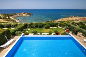 a swimming pool with a view of the ocean at Olymp Luxury Villa D - Luxury Escape with Direct Beach Access and Unique Sunsets in Paphos