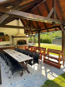 a patio with a table and chairs under a pavilion at Uvački Eko Biser 