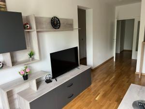 a living room with a flat screen tv on a entertainment center at Apartment Ljalja 2 in Mostar +3 photos