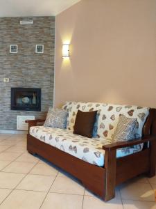 a couch in a living room with a fireplace at Villa Marta in Città della Pieve