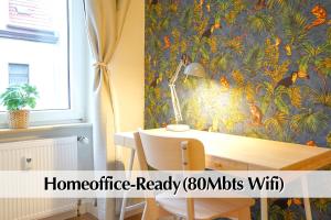a dining room with a table with a tropical wallpaper at Großraum-Apartments mit 2SZ, WZ, Küche, Smart-TV, Parken, etc in Erfurt