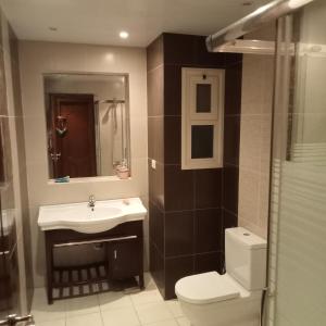 a bathroom with a sink and a toilet and a mirror at العين السخنة in Ain Sokhna