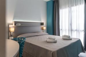 A bed or beds in a room at Hotel Cristina