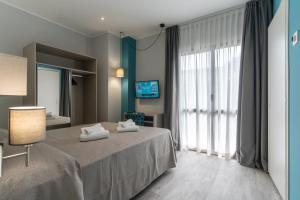 A bed or beds in a room at Hotel Cristina