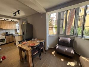 a kitchen with a table and chairs in a room at Sunny hill Apartment in Golem +23 photos