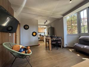 a living room with a chair with a stuffed teddy bear at Sunny hill Apartment in Golem