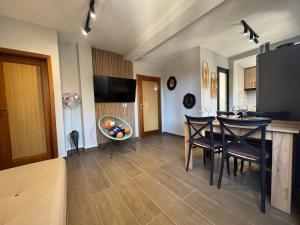a kitchen and dining room with a table and chairs at Sunny hill Apartment in Golem