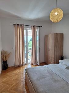 a bedroom with a bed and a large window at House Roca in Vodice +59 photos