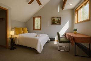 a bedroom with a bed and a table and a desk at SunnyPeace Modern Home Stay in Harwinton +23 photos
