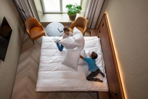 Postel nebo postele na pokoji v ubytování Hotel De Zeevaartschool