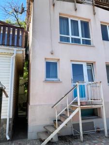 a house with a staircase in front of it at Volna in Odesa
