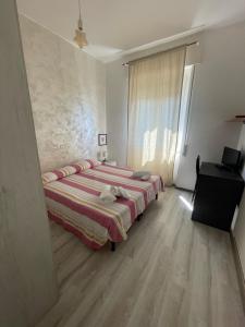 Ένα ή περισσότερα κρεβάτια σε δωμάτιο στο Piccolo Hotel di Lavagna