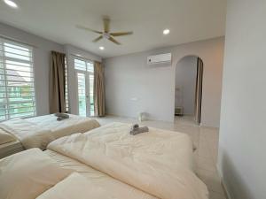 Sungai MatiにあるRasa Sayang Homestay Bukit Gambirのシーリングファン付きの客室内のベッド2台