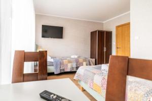 a hotel room with two beds and a television at Turkus in Międzywodzie