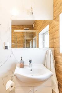 a bathroom with a sink and a mirror at Turkus in Międzywodzie +134 photos
