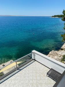 a view of the ocean from a house at Beach Apartments Luka in Tribanj-Krušćica