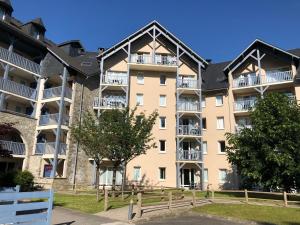 an apartment building with a fence in front of it at Appartement 203 in Saint-Lary-Soulan