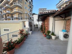 a balcony of a building with potted plants on it at Sea & Relax Villa in Sarandë