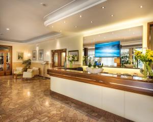 a lobby of a hotel with a reception counter at Atlantic Terme Natural Spa & Hotel in Abano Terme