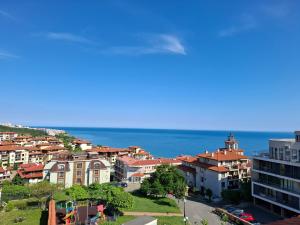 a city with houses and the ocean in the background at Sea Vista Hotel in Sveti Vlas