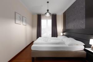 Кровать или кровати в номере Moser Living and Wellness Apartment +28 фотографий