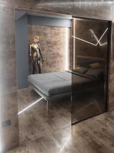 a bed in a room next to a statue at Luna Apartments B in Suceava