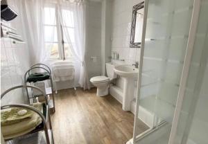 a white bathroom with a toilet and a sink at Maison de campagne 5 personnes in Peyrat-de-Bellac +19 photos