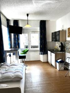 a living room with a bed and a kitchen at Ferienwohnung in Ediger Eller in Ediger-Eller