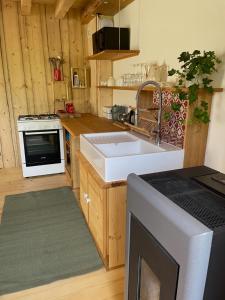 a kitchen with a sink and a stove at Maison indépendante au pied du Vercors - Gîte du Mas Roux in Château-Bernard +9 photos