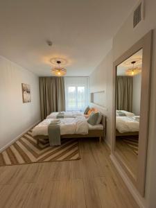 Postel nebo postele na pokoji v ubytování Raunex Apartment