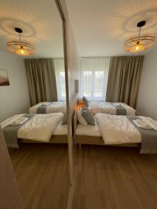 Postel nebo postele na pokoji v ubytování Raunex Apartment