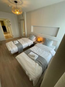 Postel nebo postele na pokoji v ubytování Raunex Apartment