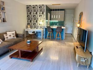 a living room with a couch and a table at BARAKA Suite BANUS in Marbella