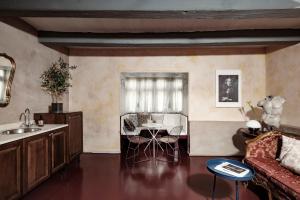 a living room with a couch and a table at Valletta Nobile by VALLETTA SUITES - a 400-year-old designer apartment in Valletta in Valletta