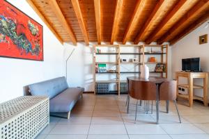 a living room with a table and a couch at TAKE OFF Airport House in Orio al Serio