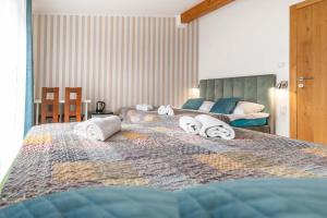 a bedroom with two beds with towels on them at Turkus in Międzywodzie