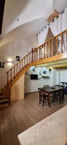 a dining room with a table and a staircase at La casa del Maestro - Gallipoli - centro storico in Gallipoli