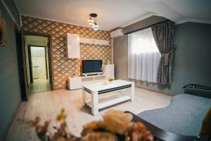 a living room with a couch and a television at HolidayHouse-Navodari in Năvodari