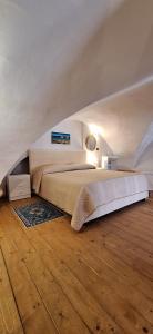 a bedroom with a large bed in an attic at La casa del Maestro - Gallipoli - centro storico in Gallipoli