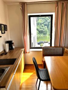 a kitchen with a table and a large window at Ferienwohnung in Ediger Eller in Ediger-Eller +24 photos