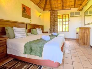 a bedroom with two beds in a room at Mabalingwe Mistykie Lodge in Warmbaths