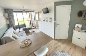 a living room with a couch and a table at Cap Coudalère entre lac et mer in Le Barcarès +34 photos