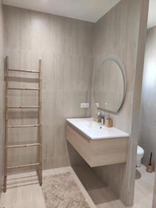 a bathroom with a sink and a mirror at Haut de Villa avec piscine in Bastelicaccia