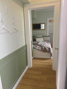 a bedroom with a bed and a door leading to a hallway at Bar'n'Bed in der schönen Koblenzer Altstadt in Koblenz