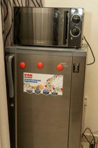 a microwave sitting on top of a refrigerator at Kigali Green View Apartments in Kigali