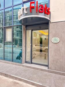 a building with a sign on the front of a store at Upart Flats by REFE in Antalya