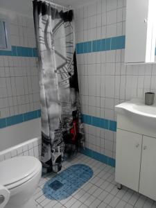 a bathroom with a toilet and a shower at Cozy flat in Nea Makri in Nea Makri +30 photos